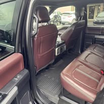Brown leather rear seats and floor after detailing